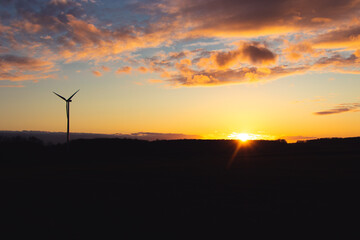 Black Silhouette of windturbines energy generator on amazing sunset at a wind farm in langenberg, germany