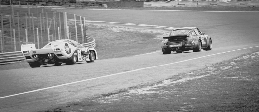 Circuit of Jarama, Madrid, Spain; April 03 2016: Black and white picture of a Porsche 934 being chased by a Rondeau m378 in a classic cars race