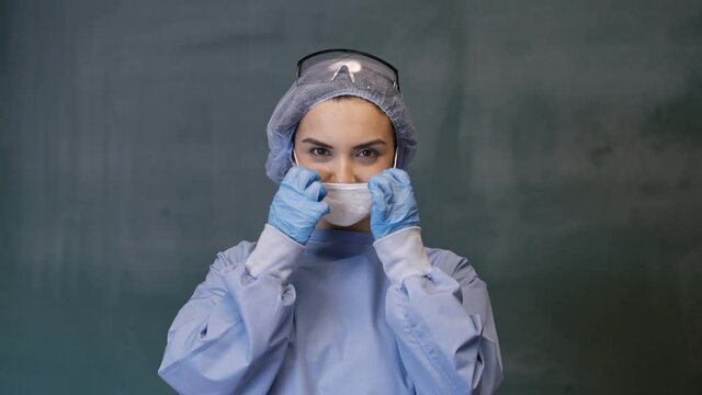 Female doctor wearing a mask smiling.Slow motion 4K video.