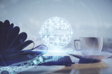 Double exposure of crypto technology drawing and desktop with coffee and items on table background....
