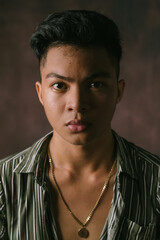 Amazing Portrait Shot a Handsome Filipino Male Model in the Philippines. Serious Asian Guy Posing at the Studio, Looking at the Camera, Posing Isolated over Studio Backdrop Background