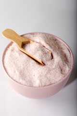 Powder Himalayan pink salt in measuring cup. Food background.