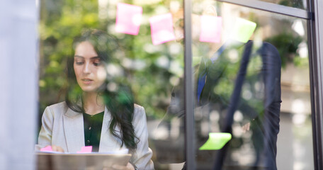 Business people meeting at customer service office and use post it notes to share idea. Business meeting and brainstorming concept.