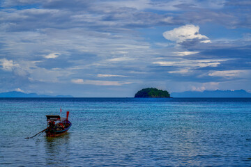Landscape of single boat on sea with ripple pattern in koh lipe islands for concept background