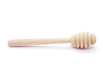 Wooden honey spoon isolated on white background. Clean Honey Honey dipper. One. Close-up.