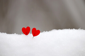 Two love hearts on the snow. Background for romantic greeting card, Valentine's day