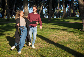 Dating Young Couple Running In A Park. A Shot Of A Dating Young Couple Running In A Park. In Love