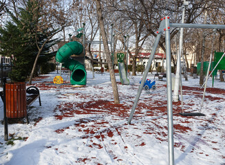 Fototapeta na wymiar Empty playground for children, during the pandemic with the SARS cov 2 virus, in the cold season.