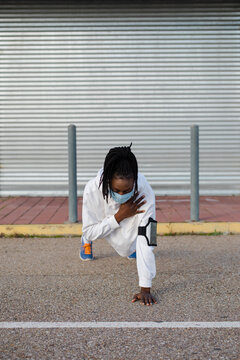 Sporty Woman Doing Plank Shoulder Tap Strength Exercise. Female Fit Athlete Training Wearing Face Mask During Covid-19 Pandemic.