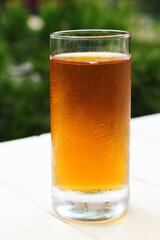 Misted glass with juice on the summer terrace.Close up photography,macro shot.