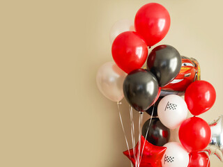 A bouquet of balloons for a birthday on a beige background. Place for text