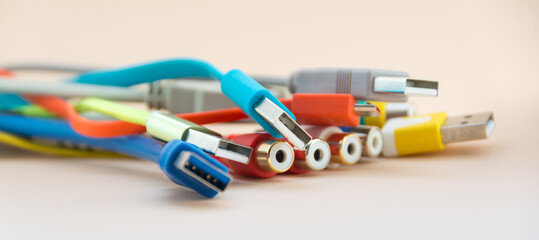 Multicolored electrical wire and cable used in communication cable network and computer system on light background.