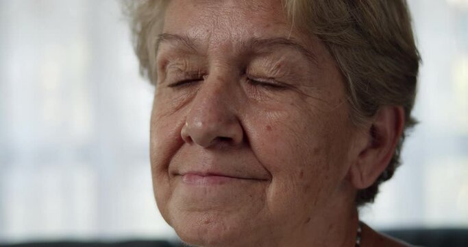 A close-up shot of an elderly woman after retirement cut short hair with light brown hair is showing a thinking expression.