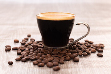 Cup of coffee with roasted coffee beans