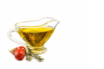 Natural vegetable oil in a small glass cup, isolated on a white background.