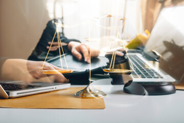 Naklejka premium Business and lawyers discussing contract papers with brass scale on desk in office. Law, legal services, advice, justice and law concept picture with film grain effect 