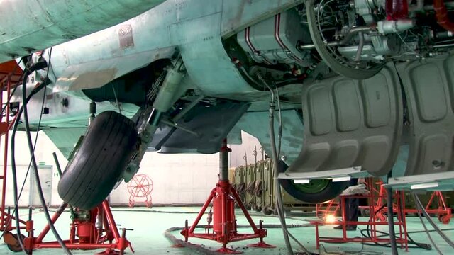 Vintage video from archive. Military attack aircraft. Sukhoi Su-25 attack aircraft (NATO codification: Frogfoot) is installed on hydraulic lifts. Checking performance of front and main landing gear.
