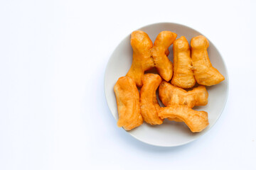 Deep-fried dough stick, chinese bread stick in white dish on white background with copy space