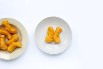Deep-fried dough stick, chinese bread stick in white dish on white background with copy space