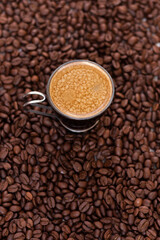 Cup of coffee with roasted coffee beans