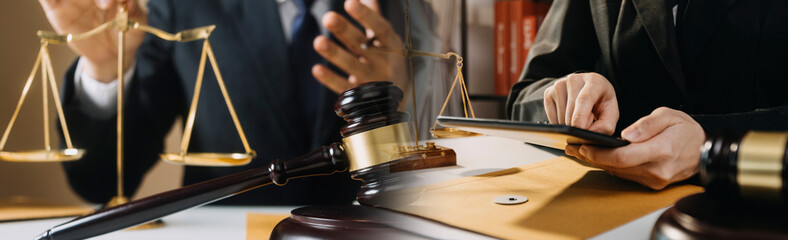 Business and lawyers discussing contract papers with brass scale on desk in office. Law, legal...
