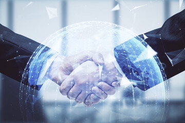 Double exposure of business theme hologram and handshake of two men. Success concept.