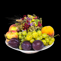 A Plate Filled with The Gifts of Summer: Apples, Grapes, Plums, Peaches and A Bouquet of Flowers from Herbs, Symbols of the Slavic Holiday Makovei (Russian Name). Cut On Black Background
