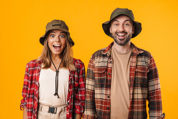 Beautiful excited couple exclaiming and looking at camera