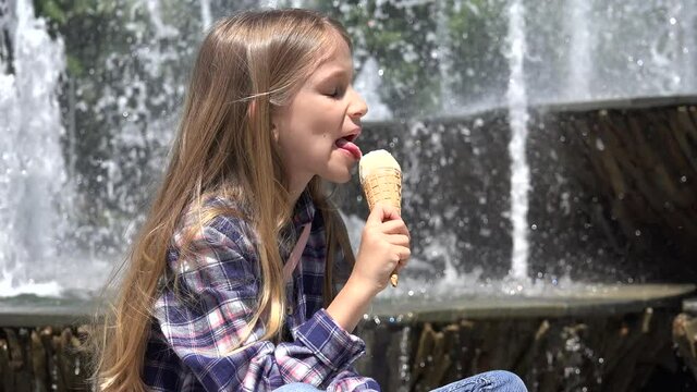 Kid Eating Ice Cream in Park, Child Relaxing by a Fountain Outdoor Girl Enjoying in Hot Summer