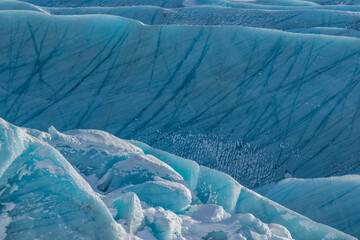 cy scenery in Iceland. Cold wind swept glaciers at sunrise.Blue Ice making abstract patterns
