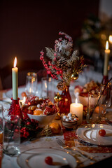 serving a Christmas dinner with candles and delicious treats