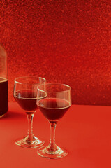 two wine glasses with bright red background