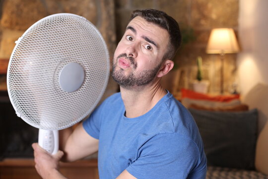 Man During Unbearable Heatwave Using Electric Fan