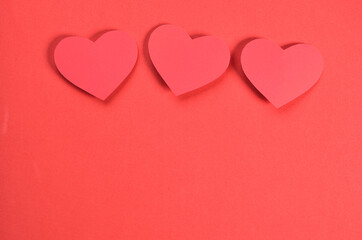 red background with three paper hearts