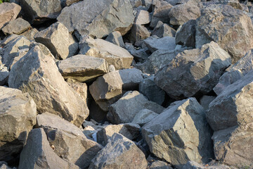 Pile of stones closeup in highlands. Destroyed rock formations in mountainous area on sunny day.