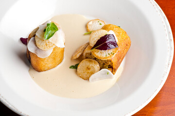 Pork belly. Pork belly seasoned with cracked black pepper and grilled. Pork served with classic steakhouse side dishes: asparagus and mashed potatoes. Classic fine dining entree.