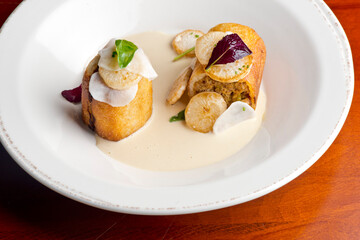 Pork belly. Pork belly seasoned with cracked black pepper and grilled. Pork served with classic steakhouse side dishes: asparagus and mashed potatoes. Classic fine dining entree.