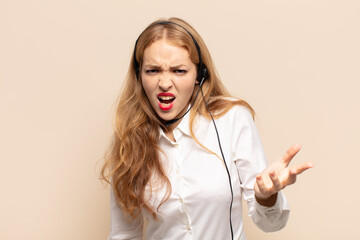 blonde woman looking angry, annoyed and frustrated screaming wtf or what’s wrong with you