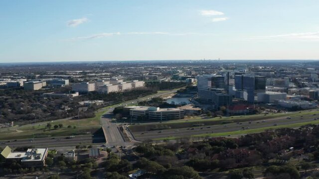 The North side of the Domain, Austin, with mopac expressway in the foreground - reverse movement mid-morning