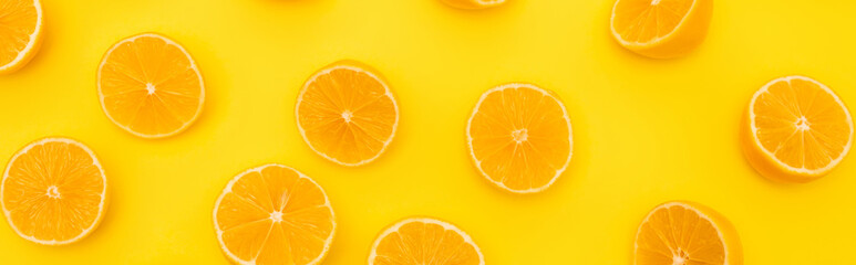 top view of ripe lemons halves isolated on yellow, banner