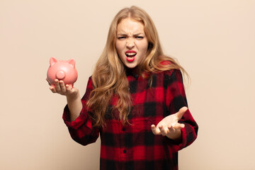 blonde woman looking angry, annoyed and frustrated screaming wtf or what’s wrong with you