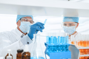 Fototapeta premium close up. scientists with test tubes in a biochemical laboratory .