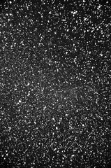 Decorative black and white background. Embossed abstraction. Dark painterly pattern. White brush points on black background. Rough background with copy space for text.