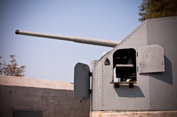 modern metal cannon for coastline or fortress defense. Barrel of gun mount on the background of sky