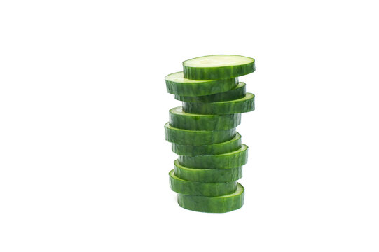  Cucumber. Stack Of Cucumber Slices Over White Background