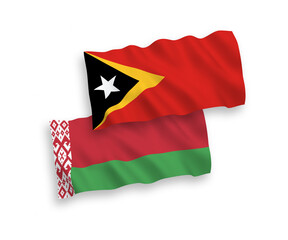 National vector fabric wave flags of East Timor and Belarus isolated on white background. 1 to 2 proportion.