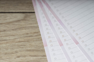 Close-up of empty lined paper blanks on wooden table.