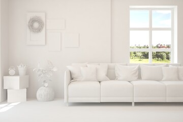 Obraz premium White living room with sofa and summer landscape in window. Scandinavian interior design. 3D illustration