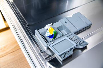 Detergent washing tablet in an open dishwasher.
