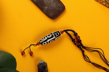 Tibetan dzi bead amulet necklace, tibetan singing bowl and other Success and prosperity symbols on...